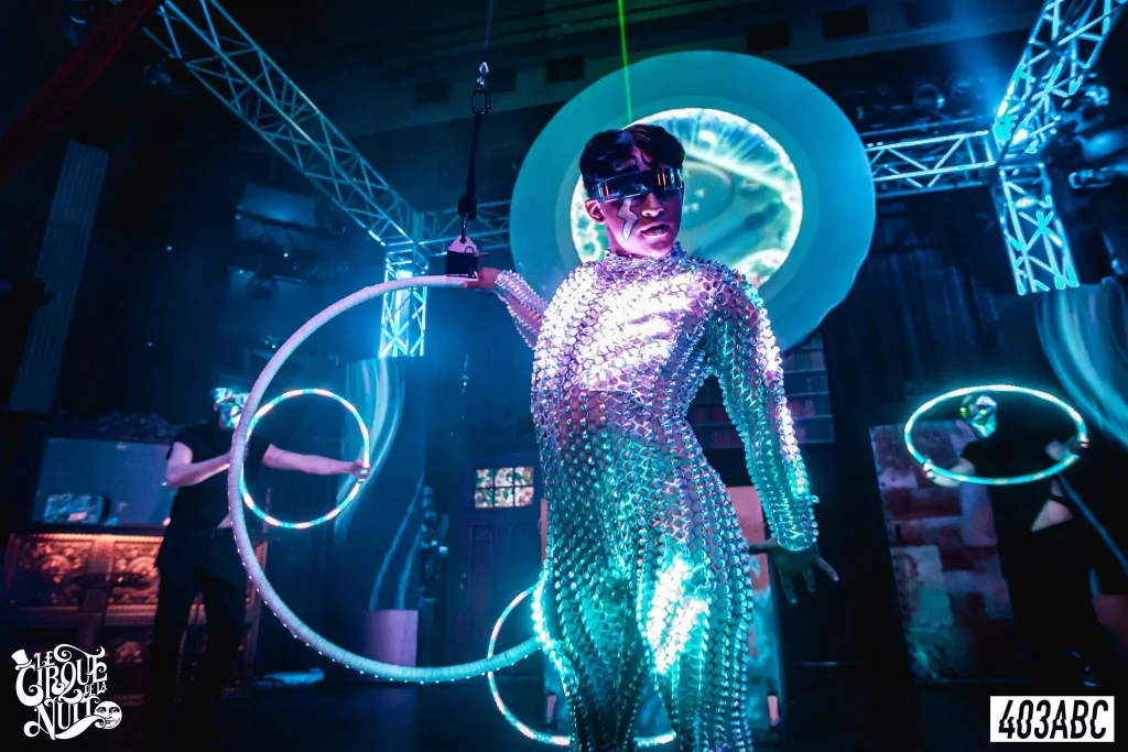 a person standing in the dark in a light up suit
