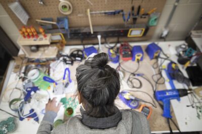 photo taken from above with a person with electronics infront of them on a table