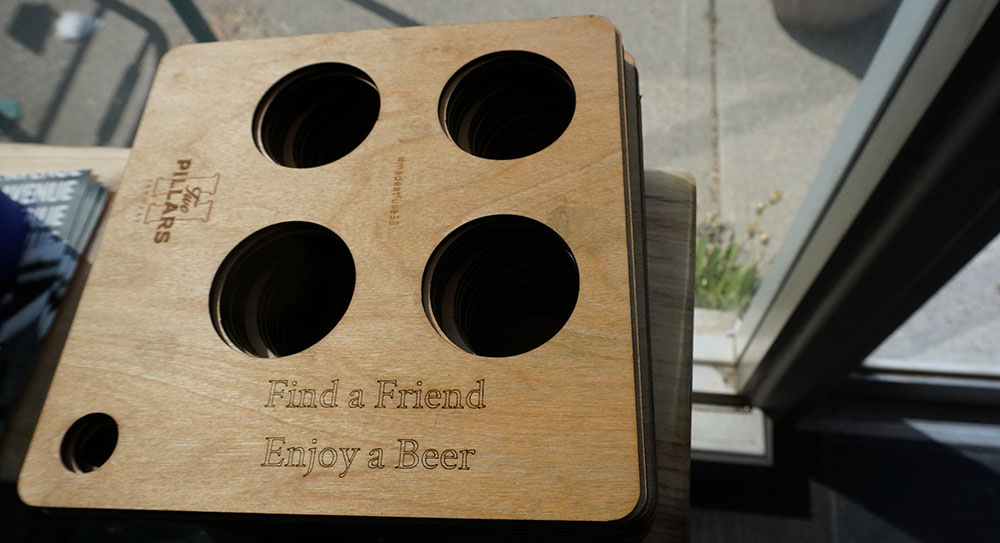 laser cut wood beer flight holder with 4 holes custom by Fuse 33 cut by a Thunder laser