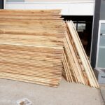 a stack of over 40 large wood triangles in a parking lot